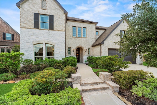 19011 Festival Hill Ct, Cypress, TX 77433 - french country inspired facade featuring stone siding, a garage, brick siding, and a shingled roof