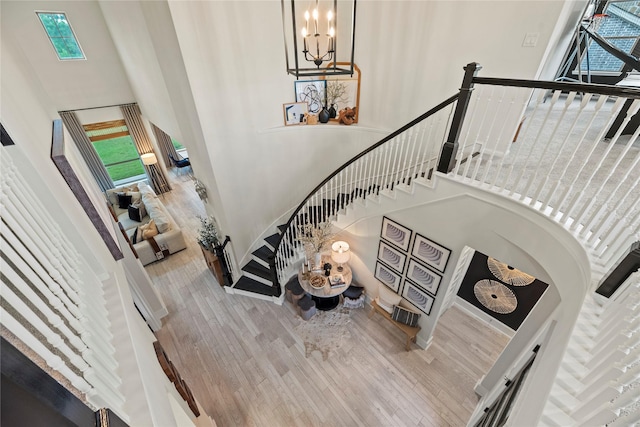 19011 Festival Hill Ct, Cypress, TX 77433 - stairway with a high ceiling, wood finished floors, plenty of natural light, and a chandelier