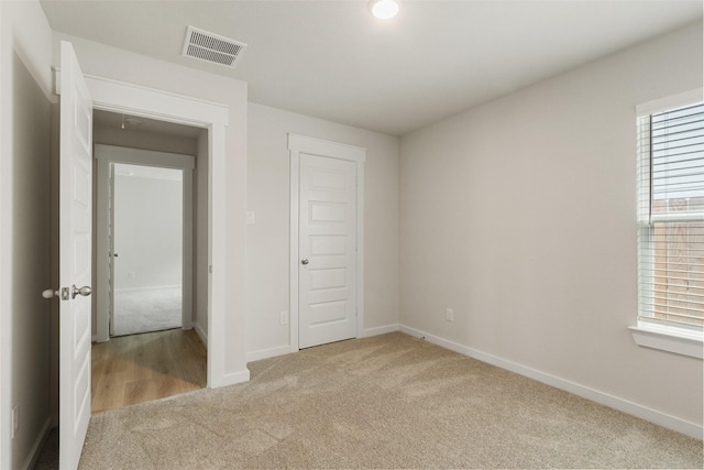 2971 Colonia Blossom Ln, Pinehurst, TX 77362 - unfurnished bedroom with carpet floors, multiple windows, and a closet