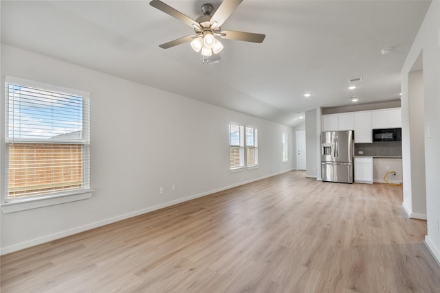 2971 Colonia Blossom Ln, Pinehurst, TX 77362 - unfurnished living room with lofted ceiling, light wood-type flooring, ceiling fan, and recessed lighting