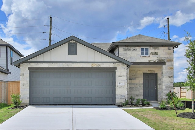 2971 Colonia Blossom Ln, Pinehurst, TX 77362 - view of front facade featuring stone siding, driveway, an attached garage, and board and batten siding