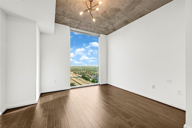 5925 Almeda Rd Unit 12403, Houston, TX 77004 - unfurnished room with a chandelier, dark wood-type flooring, and floor to ceiling windows