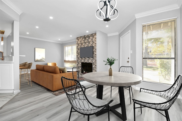 17202 Imperial Valley Dr Unit 3, Houston, TX 77060 - dining room featuring crown molding, recessed lighting, light wood-style floors, and a fireplace