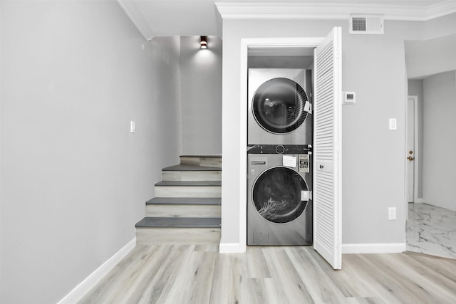17202 Imperial Valley Dr Unit 3, Houston, TX 77060 - washroom featuring estacked washer and dryer, crown molding, and wood finished floors