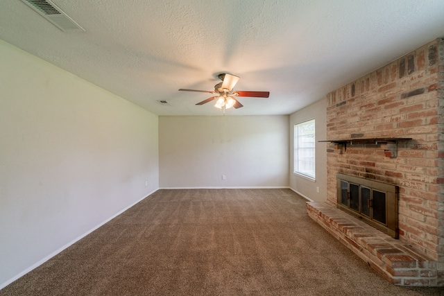10006 Peachridge Dr, Houston, TX 77070 - unfurnished living room featuring ceiling fan, a brick fireplace, carpet floors, and a textured ceiling