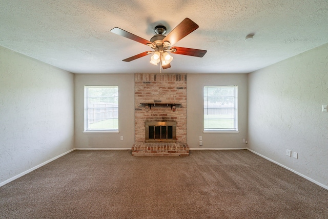 10006 Peachridge Dr, Houston, TX 77070 - unfurnished living room with plenty of natural light, a textured ceiling, carpet floors, ceiling fan, and a brick fireplace