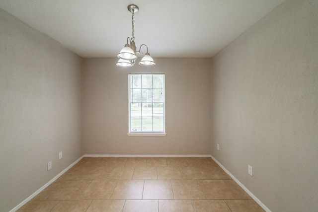 10006 Peachridge Dr, Houston, TX 77070 - empty room with light tile patterned floors and a chandelier