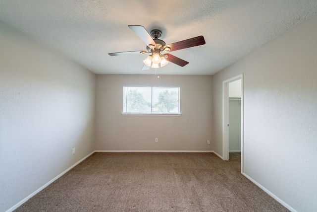 10006 Peachridge Dr, Houston, TX 77070 - unfurnished bedroom with carpet, a ceiling fan, a walk in closet, and a textured ceiling
