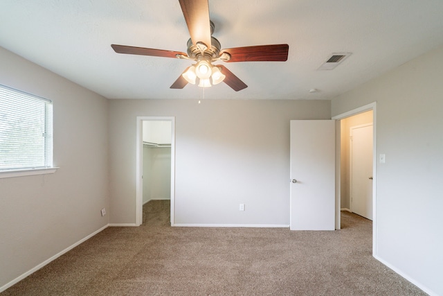 10006 Peachridge Dr, Houston, TX 77070 - unfurnished bedroom with carpet floors, a walk in closet, and a ceiling fan