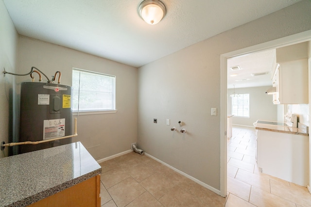 10006 Peachridge Dr, Houston, TX 77070 - laundry room featuring water heater, washer hookup, hookup for an electric dryer, and light tile patterned floors