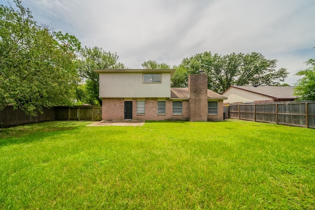 10006 Peachridge Dr, Houston, TX 77070 - rear view of property with a fenced backyard, a chimney, brick siding, and a patio