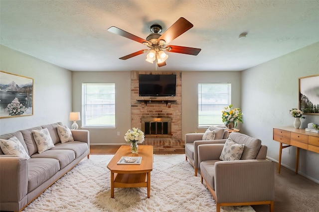 10006 Peachridge Dr, Houston, TX 77070 - living room featuring plenty of natural light, ceiling fan, a brick fireplace, and a textured ceiling