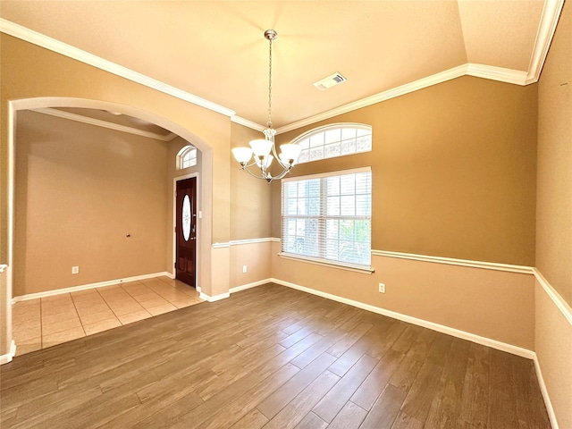 4315 Wellington Grove Ln, Katy, TX 77494 - spare room featuring wood finished floors, arched walkways, a chandelier, ornamental molding, and vaulted ceiling