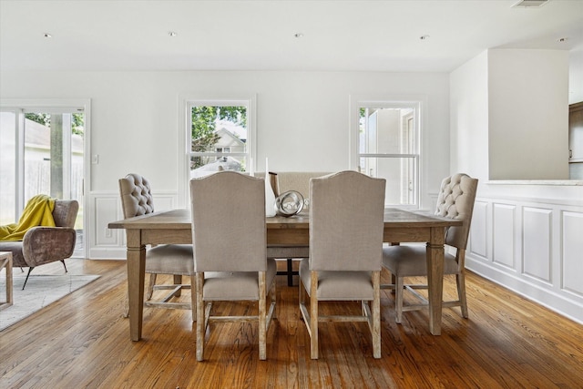 2037 Banks, Houston, TX 77098 - dining space with a decorative wall, healthy amount of natural light, light wood-style floors, and wainscoting