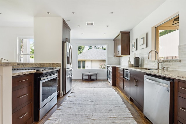 2037 Banks, Houston, TX 77098 - kitchen with appliances with stainless steel finishes, wood finished floors, light stone countertops, dark brown cabinetry, and recessed lighting