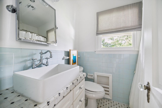 2037 Banks, Houston, TX 77098 - bathroom with tile walls, tile patterned flooring, vanity, and a wainscoted wall