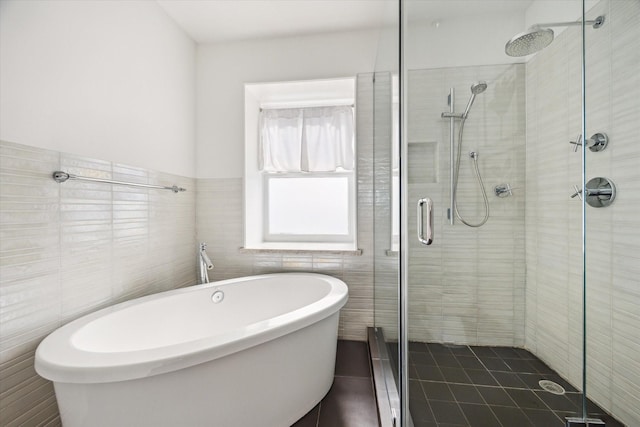 2037 Banks, Houston, TX 77098 - bathroom with tile walls, a shower stall, a soaking tub, and tile patterned floors