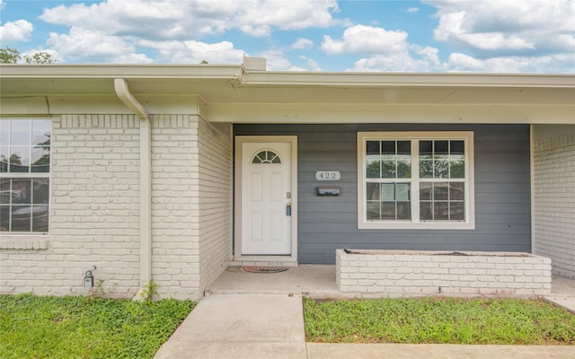 422 Gammon Dr, Houston, TX 77022 - doorway to property featuring a porch and brick siding