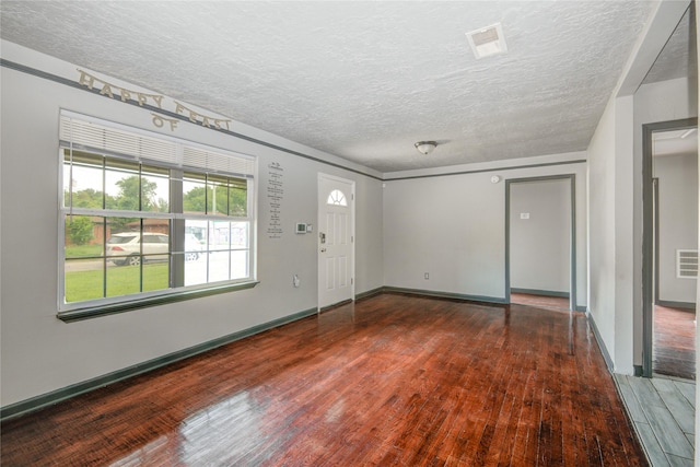 422 Gammon Dr, Houston, TX 77022 - entrance foyer with hardwood / wood-style flooring and a textured ceiling