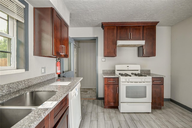 422 Gammon Dr, Houston, TX 77022 - kitchen with white appliances, under cabinet range hood, wood tiled floors, a textured ceiling, and light stone counters
