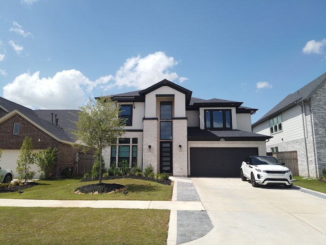31422 Beacon Cove Trl, Fulshear, TX 77441 - modern home featuring concrete driveway, stucco siding, a garage, and a front yard