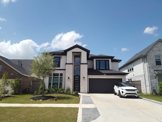 31422 Beacon Cove Trl, Fulshear, TX 77441 - contemporary home with driveway, a garage, a front lawn, and stucco siding