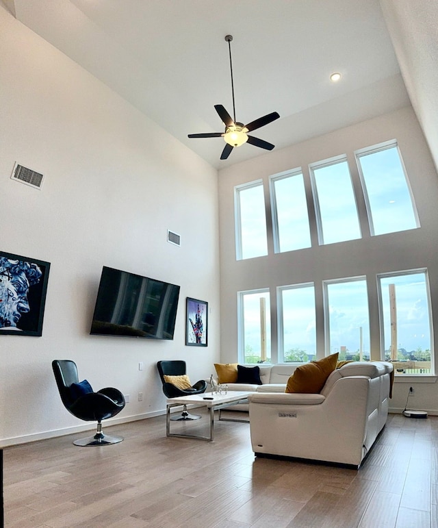 31422 Beacon Cove Trl, Fulshear, TX 77441 - living area featuring a high ceiling, plenty of natural light, light wood-type flooring, a ceiling fan, and recessed lighting