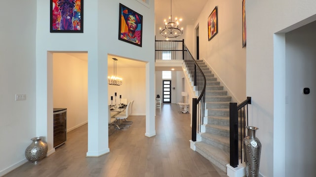31422 Beacon Cove Trl, Fulshear, TX 77441 - foyer featuring a chandelier, stairway, wood finished floors, and a high ceiling