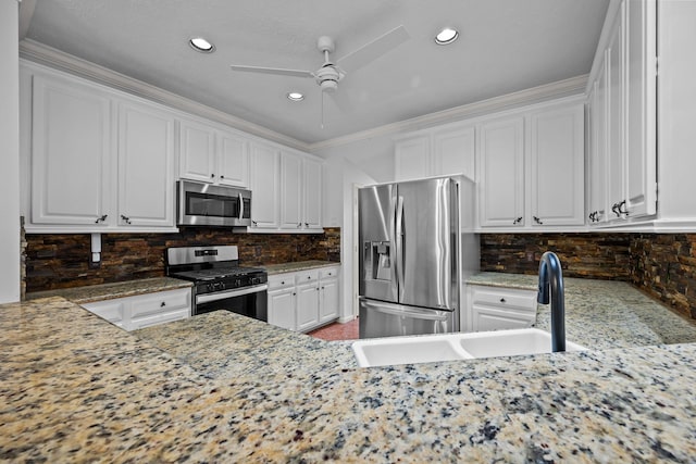 5110 Scottline Dr, Pasadena, TX 77505 - kitchen with stainless steel appliances, white cabinetry, ceiling fan, tasteful backsplash, and recessed lighting