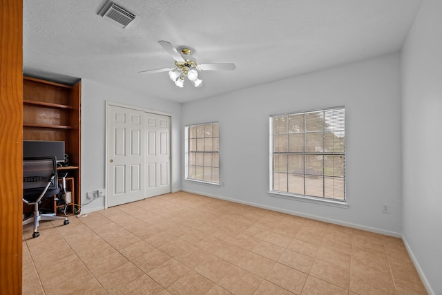 5110 Scottline Dr, Pasadena, TX 77505 - unfurnished office featuring plenty of natural light, ceiling fan, tile patterned floors, and a textured ceiling
