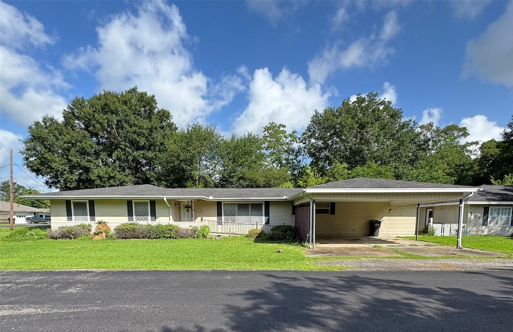 189 Hilldale Dr, Nederland, TX 77627 - ranch-style home with a front yard, a carport, and driveway