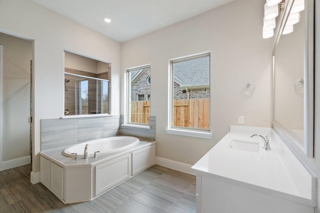 914 Hooks Trl, League City, TX 77573 - bathroom featuring a shower stall, a garden tub, vanity, and recessed lighting