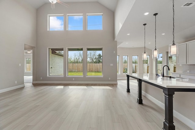 914 Hooks Trl, League City, TX 77573 - kitchen with light countertops, ceiling fan, a large island, white cabinets, and open floor plan
