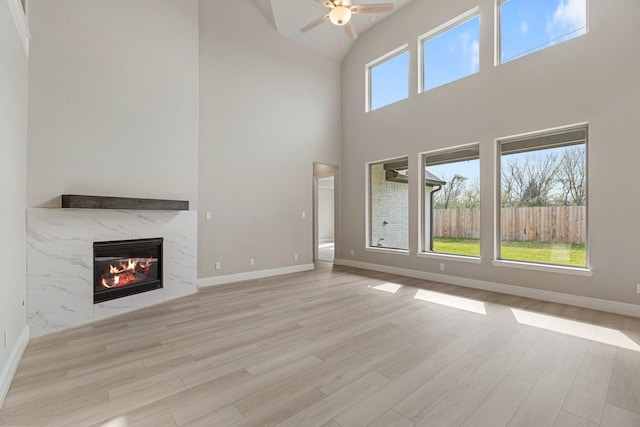 914 Hooks Trl, League City, TX 77573 - unfurnished living room featuring ceiling fan, a fireplace, wood finished floors, and high vaulted ceiling