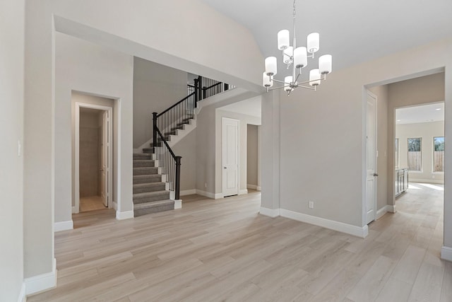 914 Hooks Trl, League City, TX 77573 - empty room with stairs, a chandelier, light wood-style floors, and lofted ceiling