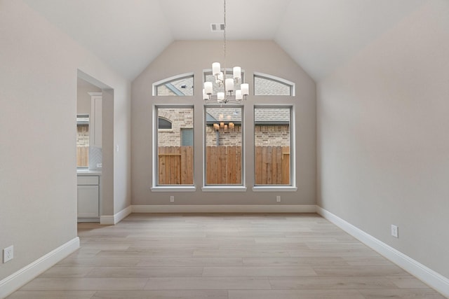 914 Hooks Trl, League City, TX 77573 - unfurnished dining area with a chandelier, light wood-style floors, and vaulted ceiling