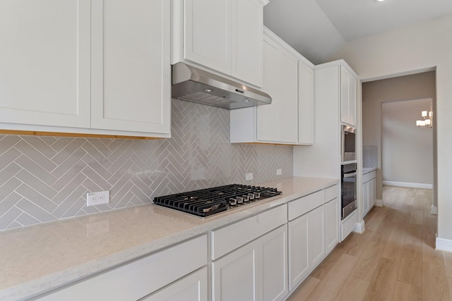 914 Hooks Trl, League City, TX 77573 - kitchen featuring exhaust hood, appliances with stainless steel finishes, decorative backsplash, white cabinets, and light wood-type flooring