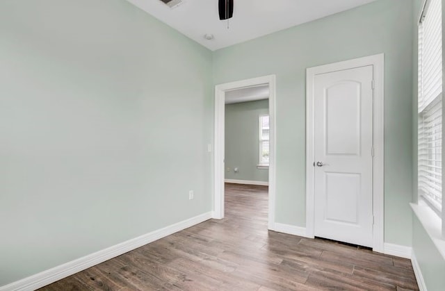 2245 Wilson St, Beaumont, TX 77703 - unfurnished bedroom featuring wood finished floors and ceiling fan