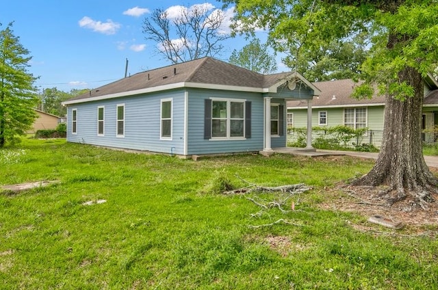 2245 Wilson St, Beaumont, TX 77703 - rear view of property featuring a lawn