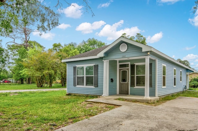 2245 Wilson St, Beaumont, TX 77703 - shotgun-style home featuring a front lawn and a porch