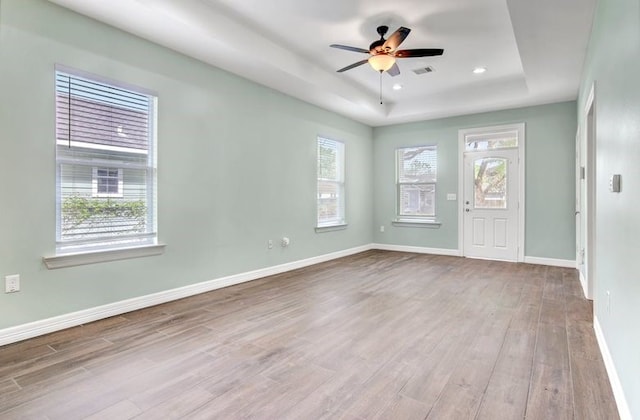2245 Wilson St, Beaumont, TX 77703 - spare room featuring a raised ceiling, wood finished floors, ceiling fan, and recessed lighting