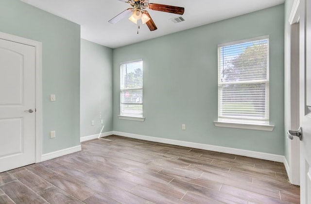 2245 Wilson St, Beaumont, TX 77703 - spare room featuring healthy amount of natural light, wood finished floors, and a ceiling fan