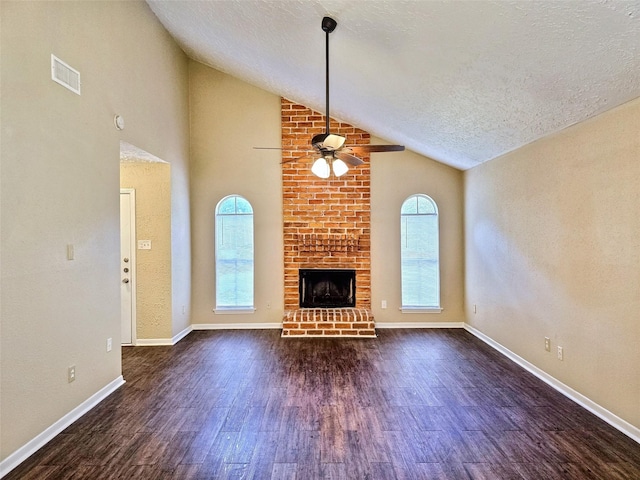16502 Royal Mile Ln, Houston, TX 77084 - unfurnished living room with a ceiling fan, wood finished floors, a fireplace, a textured ceiling, and high vaulted ceiling