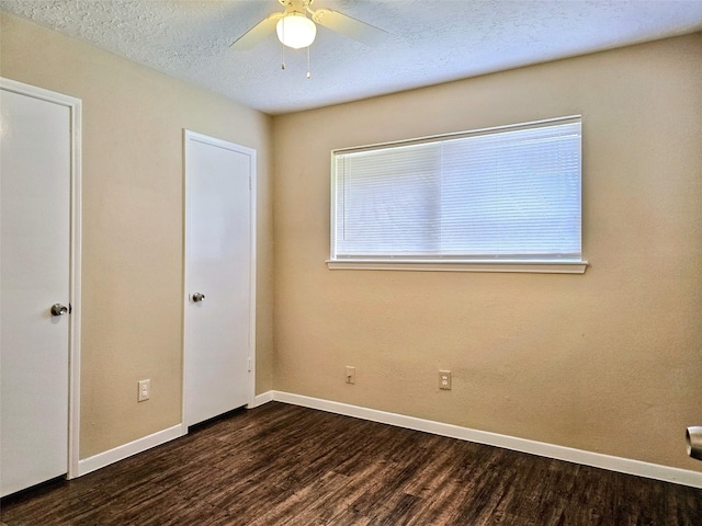 16502 Royal Mile Ln, Houston, TX 77084 - unfurnished bedroom with dark wood-type flooring, a textured ceiling, and a ceiling fan