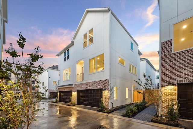 3057 Hicks St, Houston, TX 77007 - view of front facade with an attached garage, driveway, and brick siding