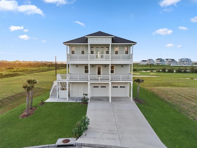 21330 Scissor Tail Ln, Galveston, TX 77554 - coastal home featuring a balcony, stairs, driveway, a garage, and a front yard