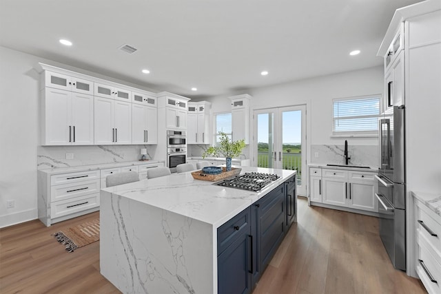 21330 Scissor Tail Ln, Galveston, TX 77554 - kitchen featuring appliances with stainless steel finishes, white cabinetry, plenty of natural light, and recessed lighting