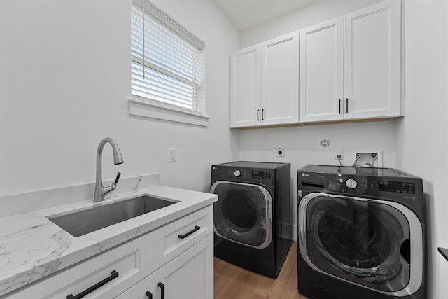 21330 Scissor Tail Ln, Galveston, TX 77554 - laundry room with cabinet space, separate washer and dryer, and light wood-type flooring