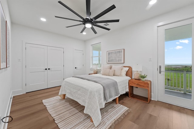 21330 Scissor Tail Ln, Galveston, TX 77554 - bedroom featuring access to outside, light wood-type flooring, recessed lighting, ceiling fan, and multiple closets