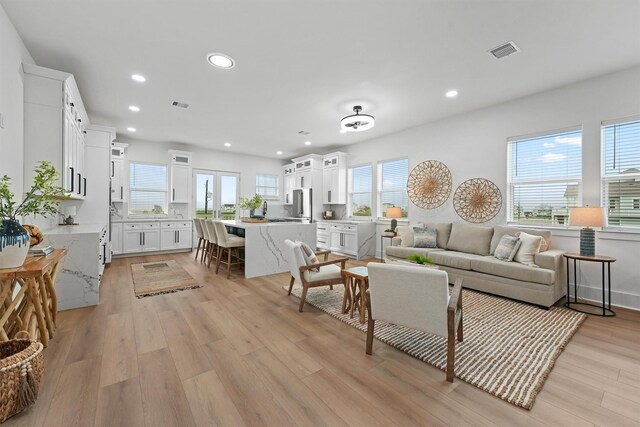 21330 Scissor Tail Ln, Galveston, TX 77554 - living room featuring light wood-style flooring and recessed lighting
